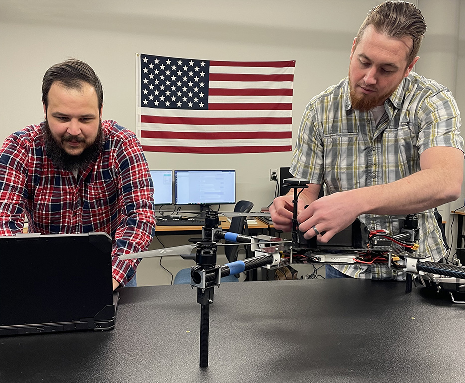 Berry Aviation employees perform final checks on a drone.